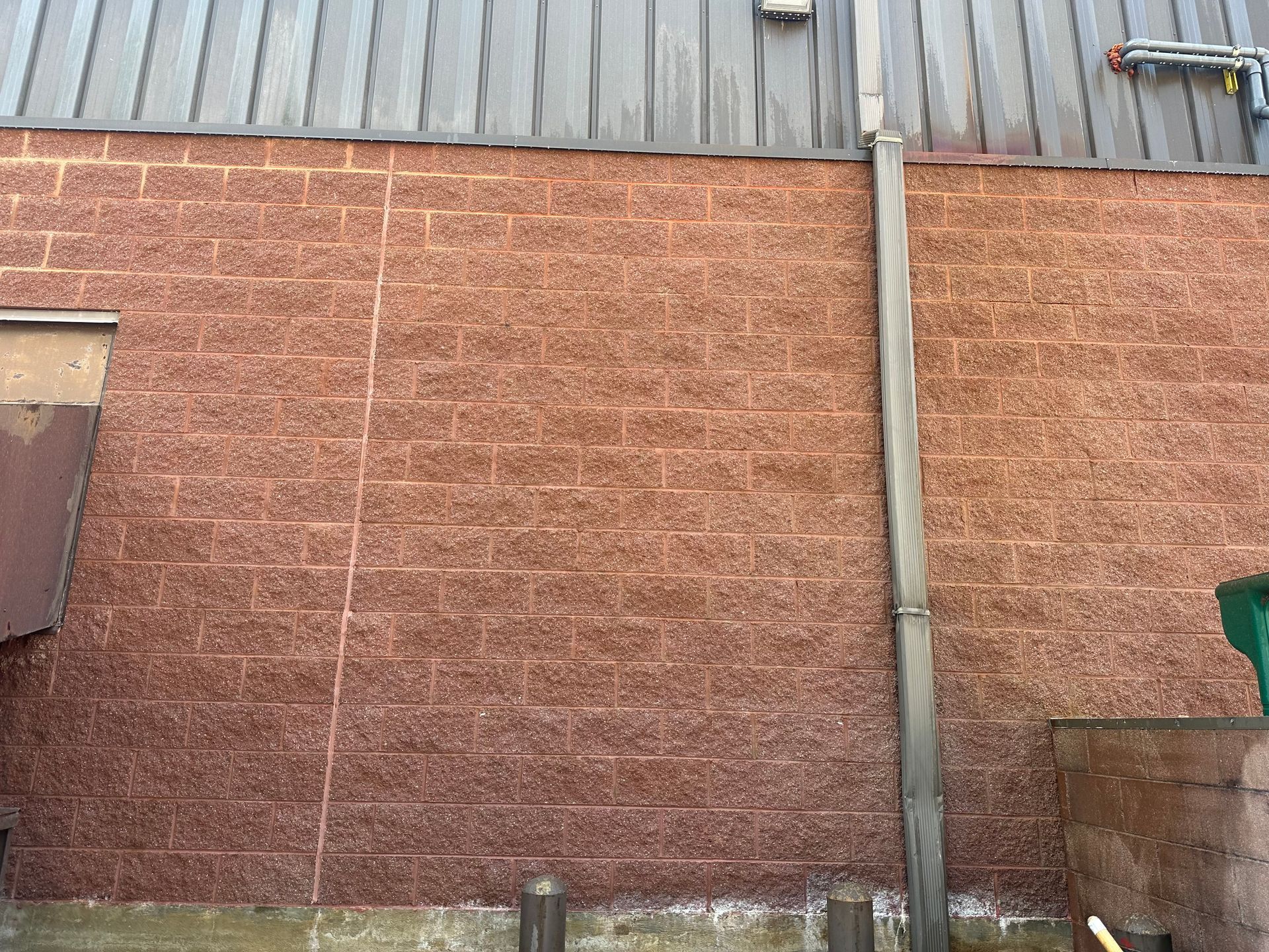 a brick wall with a metal roof