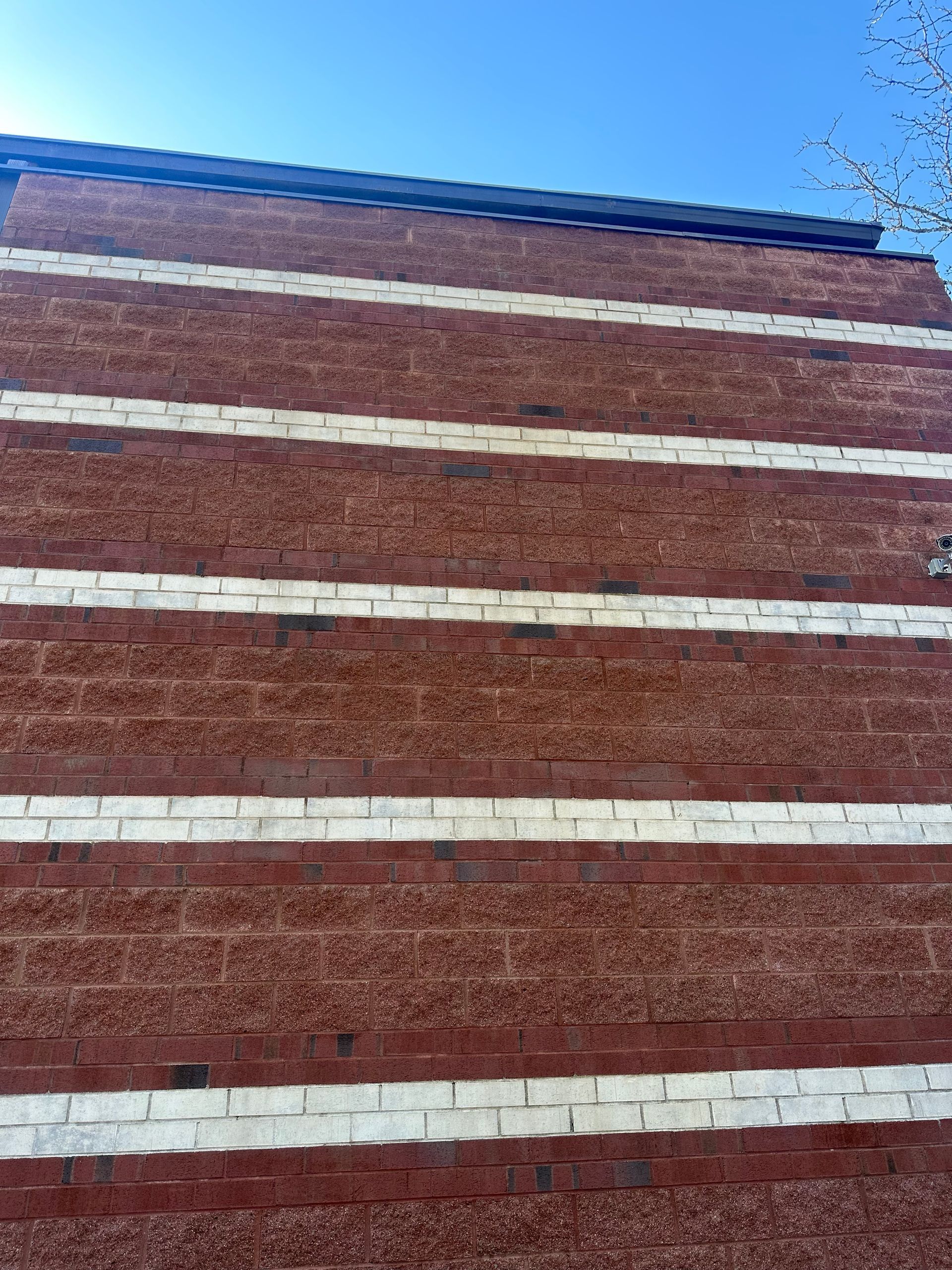 a red brick wall with white stripes on it