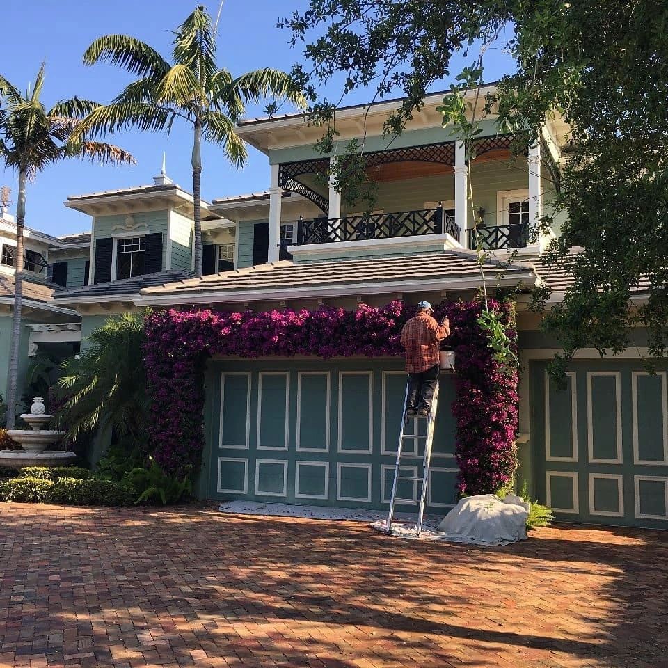 A large blue house with white trim and shutters