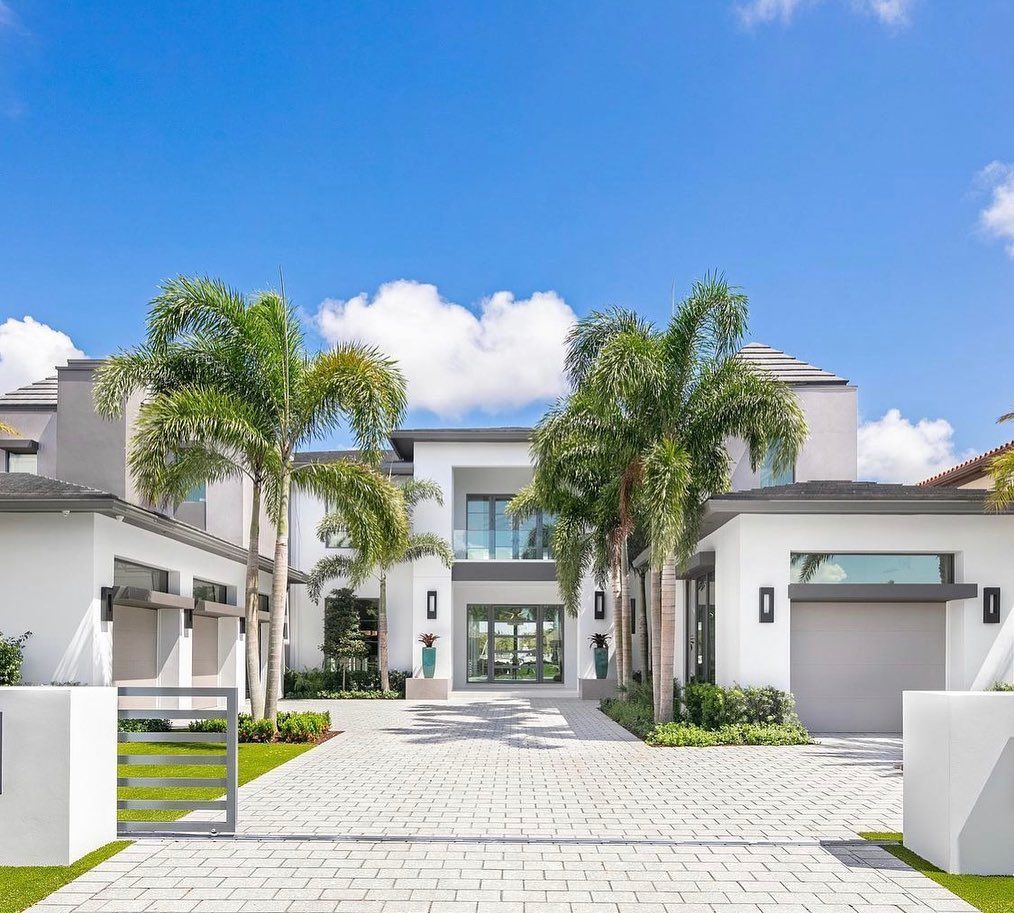 A large house with a lot of trees in front of it