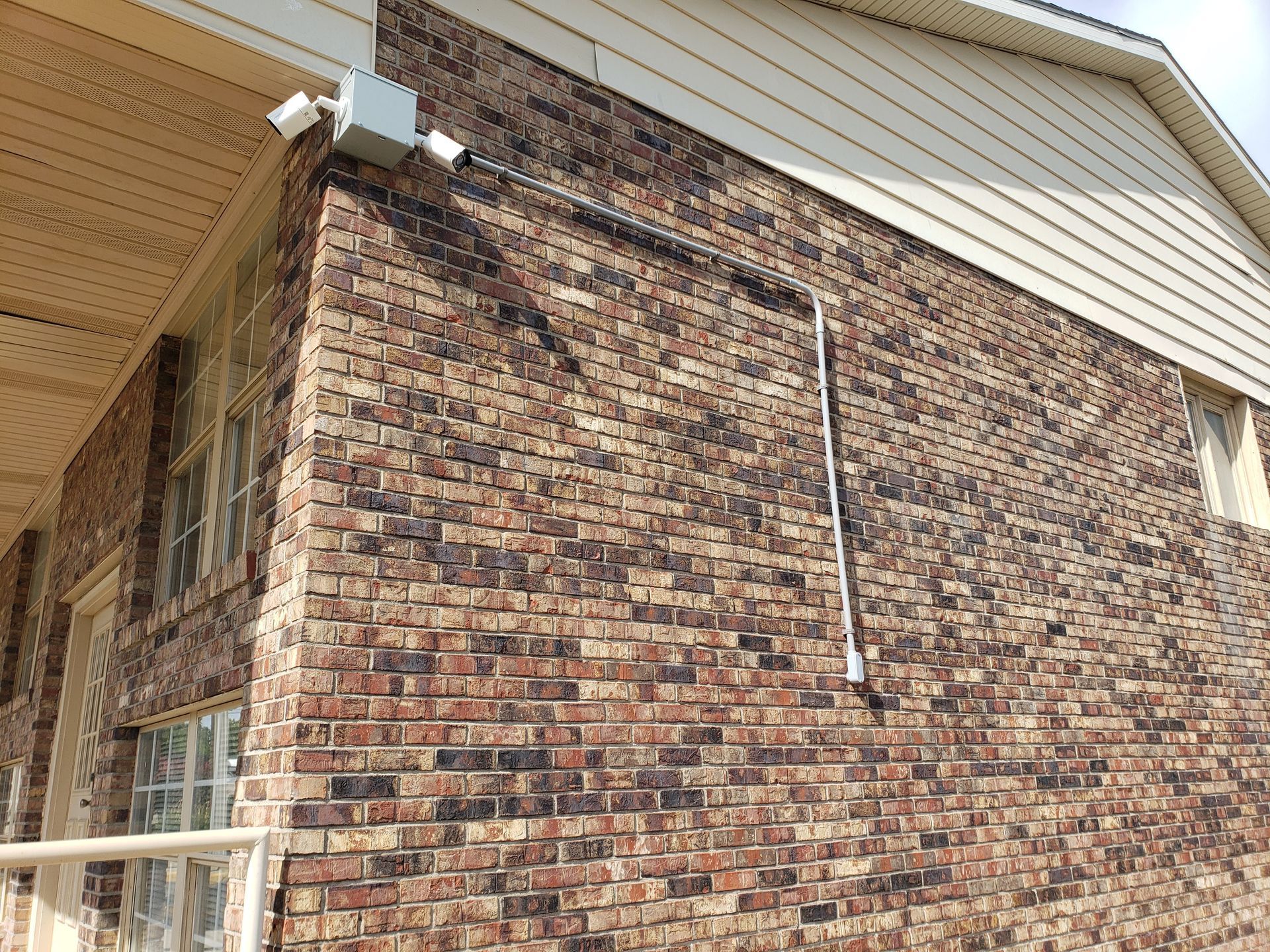 Brick building exterior with security cameras mounted.