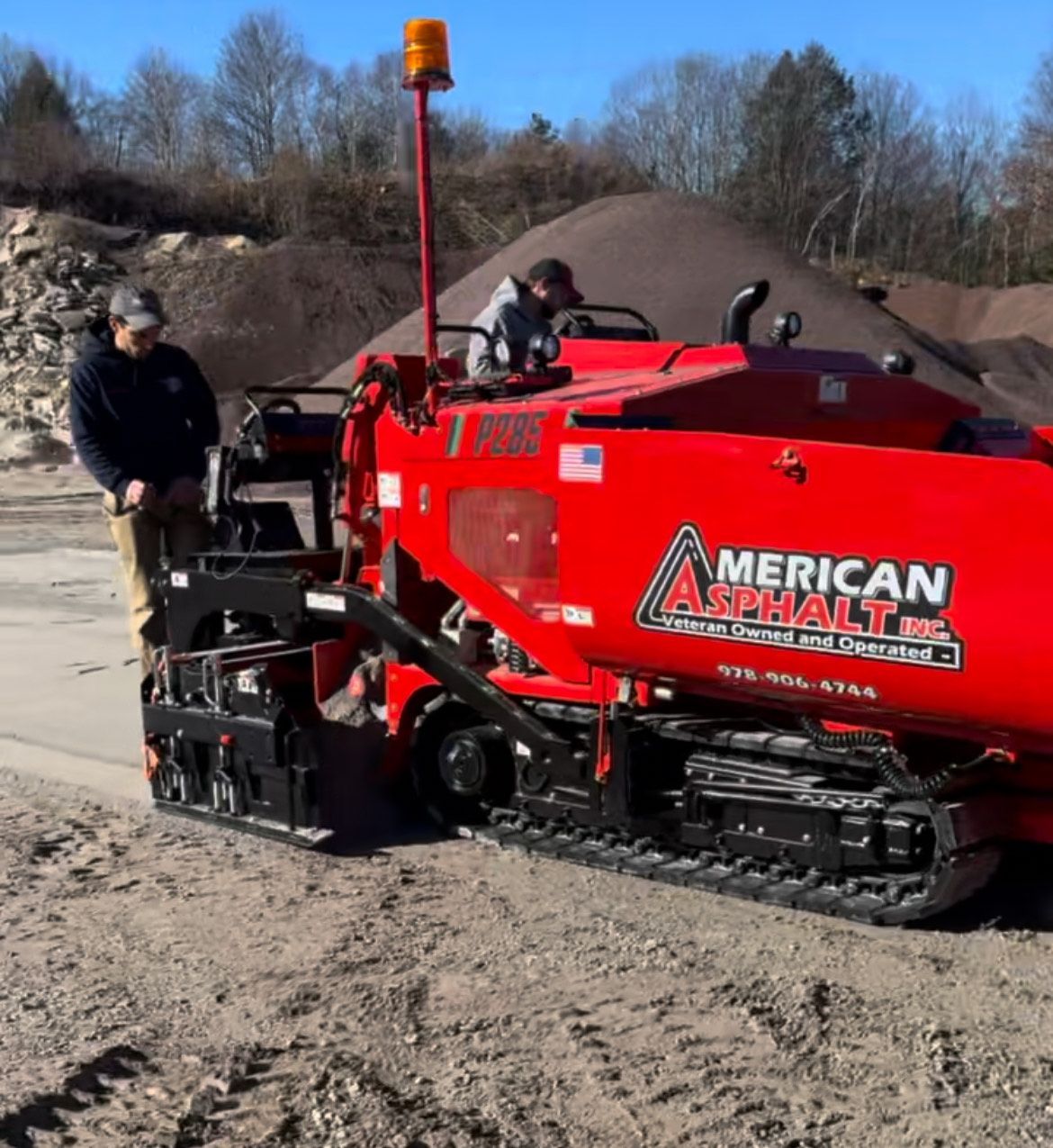 A red machine that says ' american asphalt ' on it
