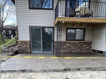 A house with a sliding glass door and a balcony