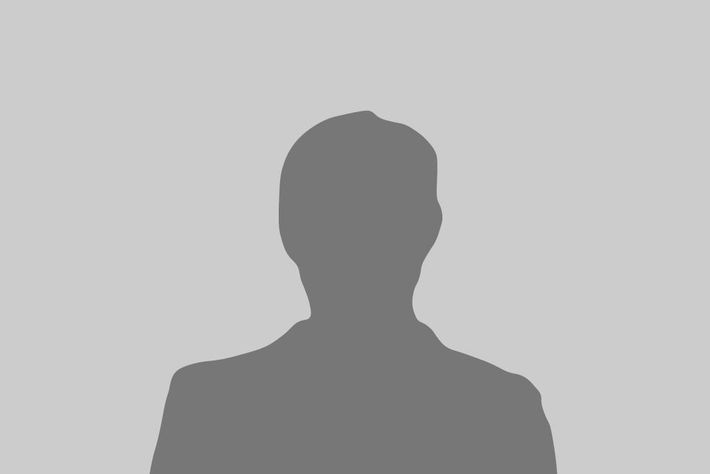 A silhouette of a man without a face on a gray background.