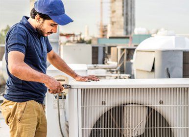 Electrician man fixing unit of an air conditioner