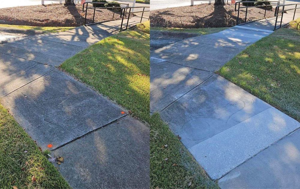 Comparison of a dirty and cleaned concrete sidewalk, bordered by grass.