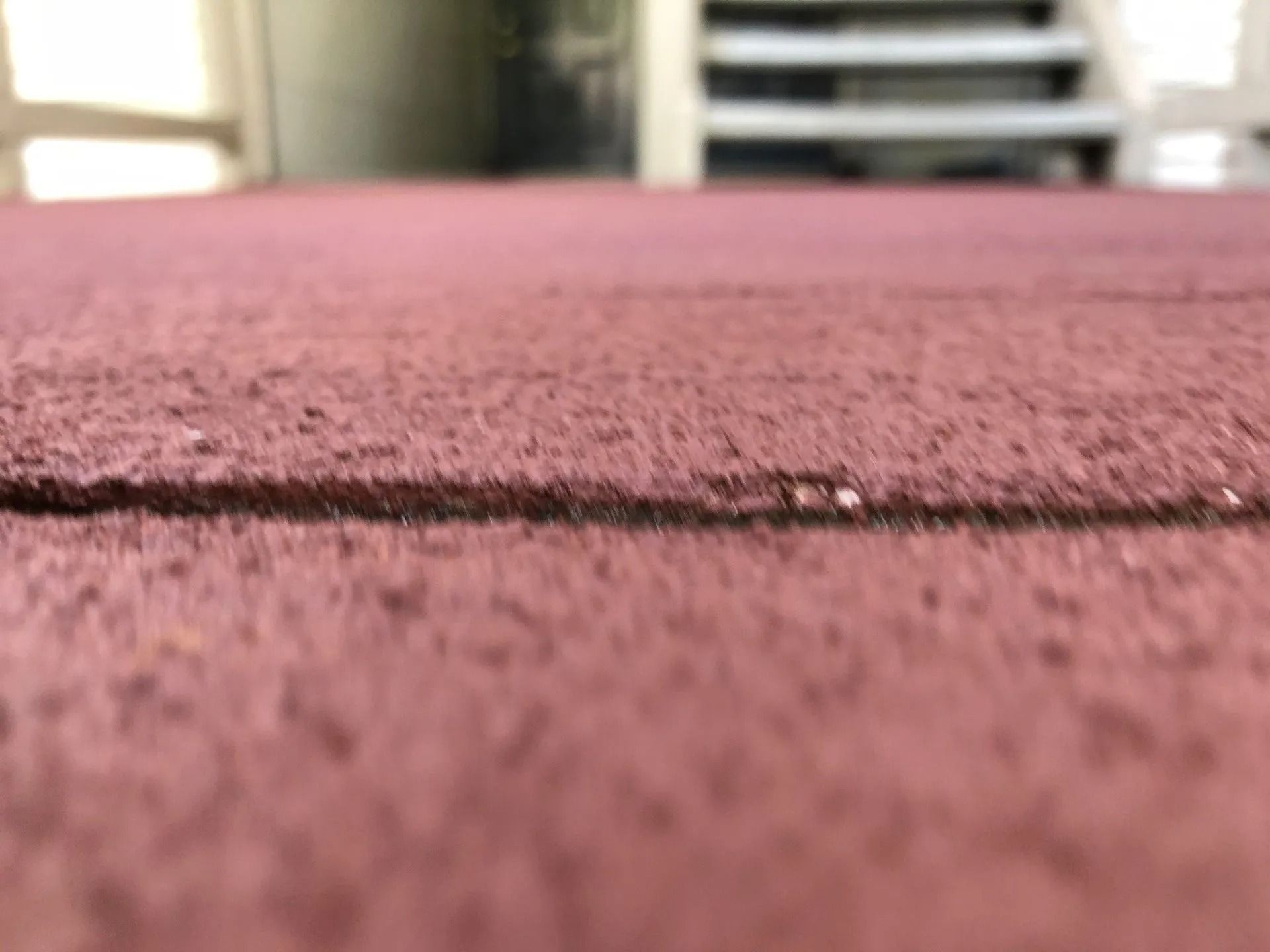 Close-up of a textured, reddish-brown surface with a visible horizontal seam.