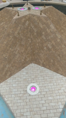 A stone-tiled fountain feature with a star-shaped top, accented by three glowing purple underwater lights.