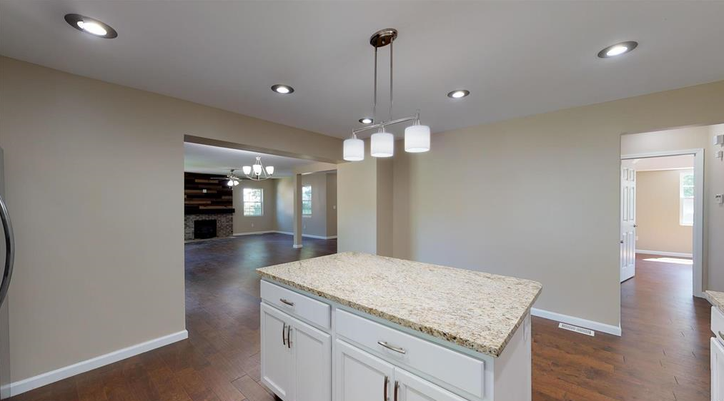 There is a large island in the middle of the kitchen.