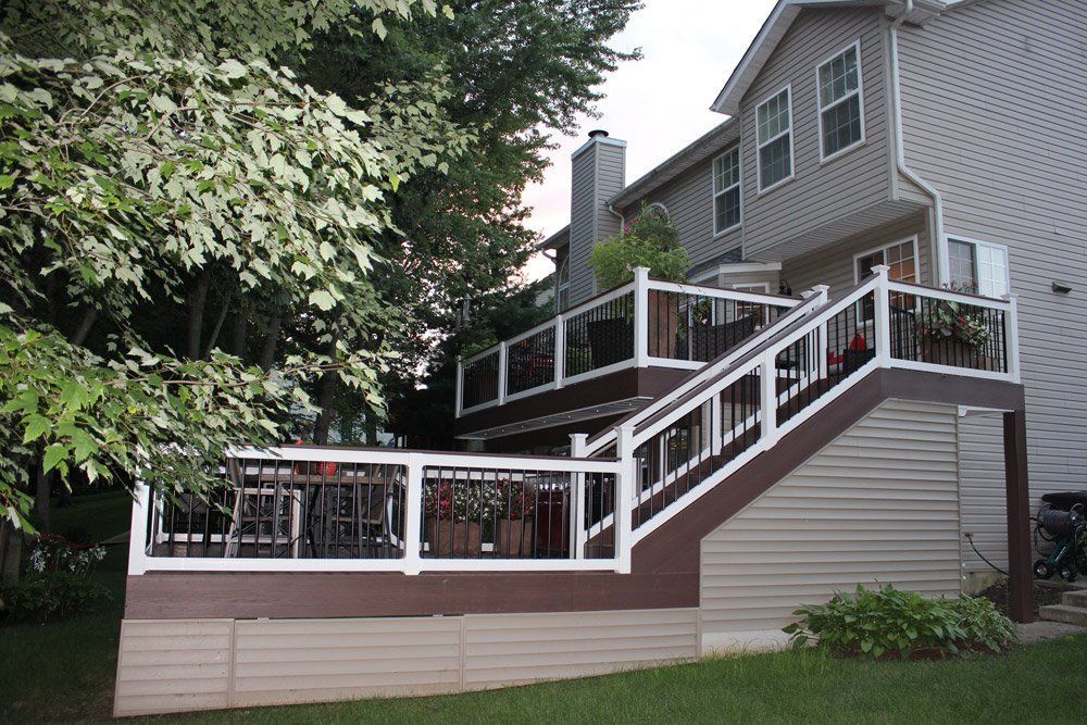 A house with a deck and stairs leading up to it