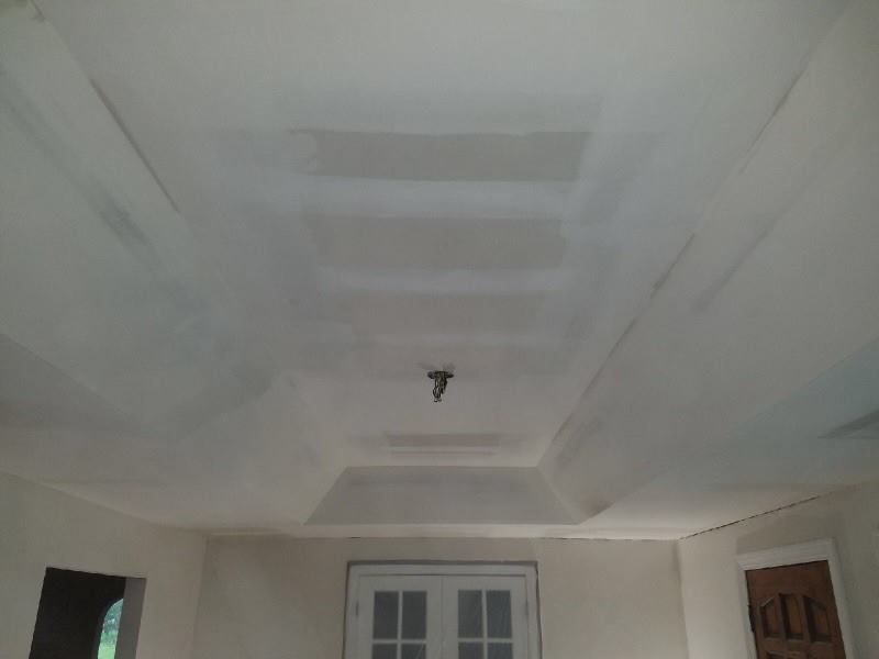 A room with a white ceiling and a door.