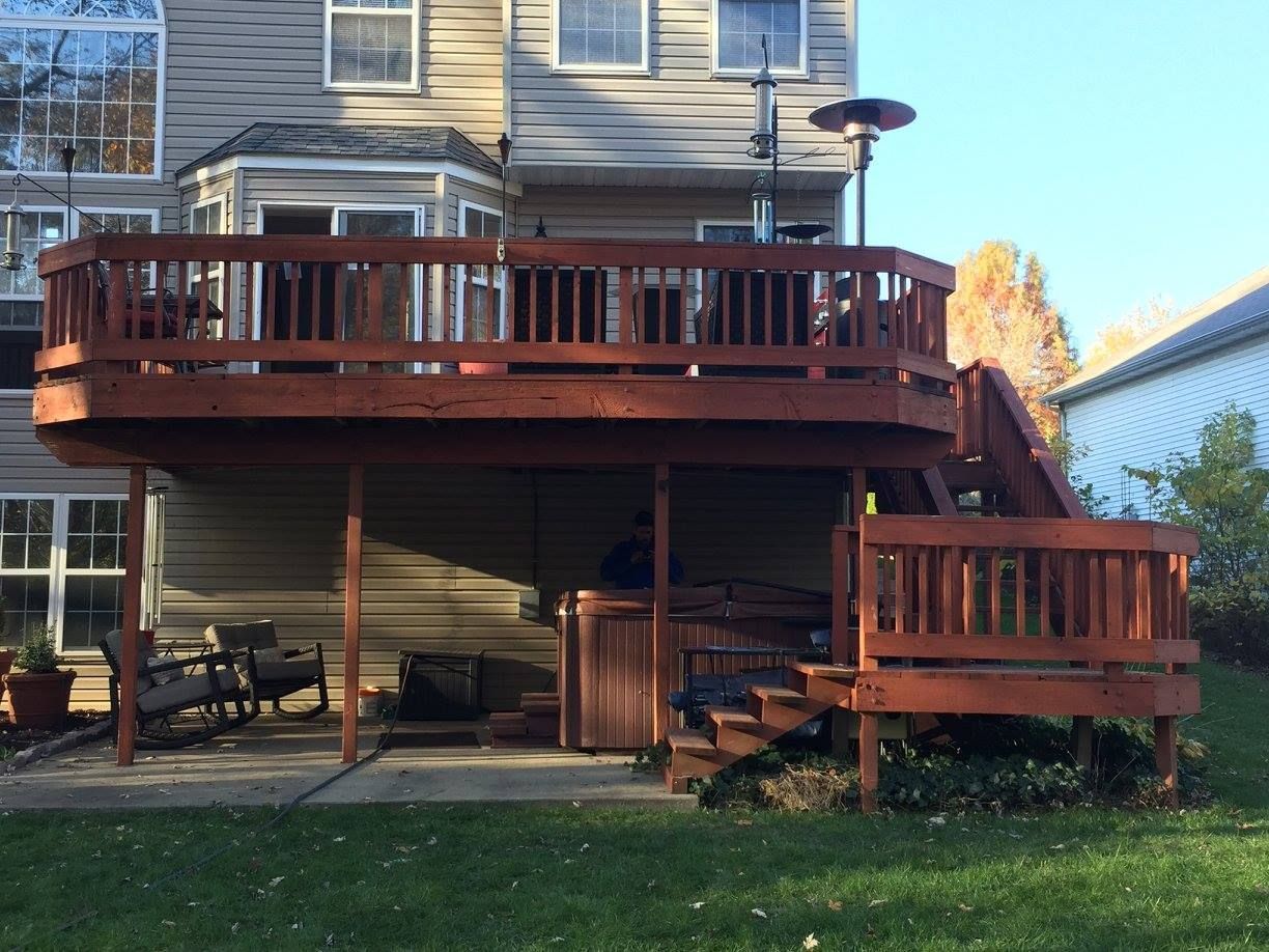 A large wooden deck with stairs leading up to it
