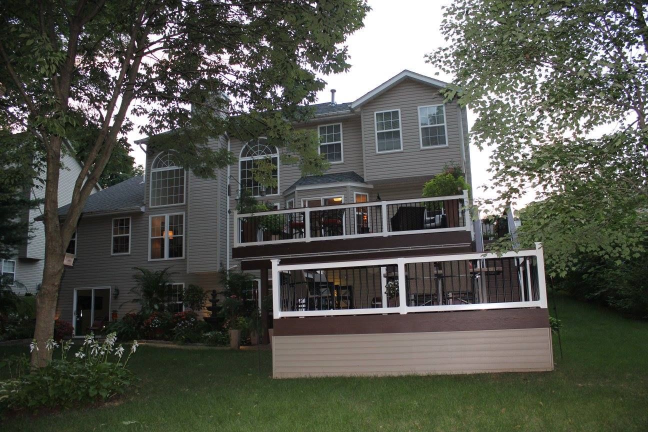 A large house with a large deck in the backyard