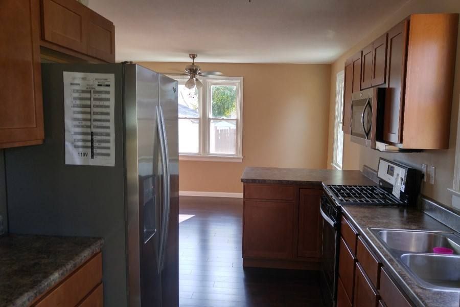 A kitchen with stainless steel appliances and wooden cabinets
