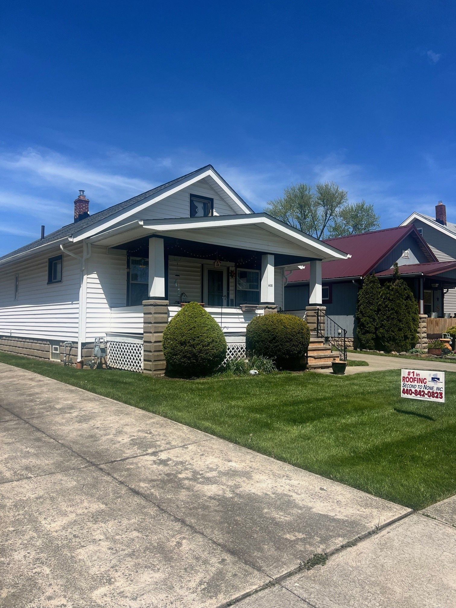 A house with a for sale sign in front of it.