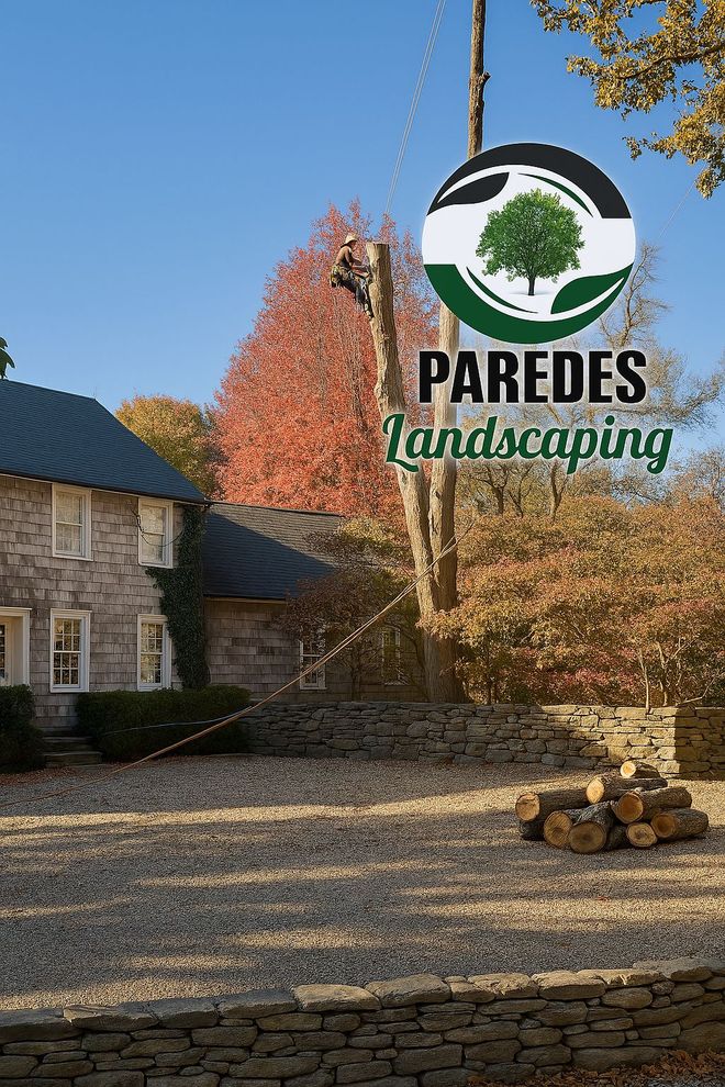 PAREDES Landscaping logo over a stone driveway, house, and autumn trees