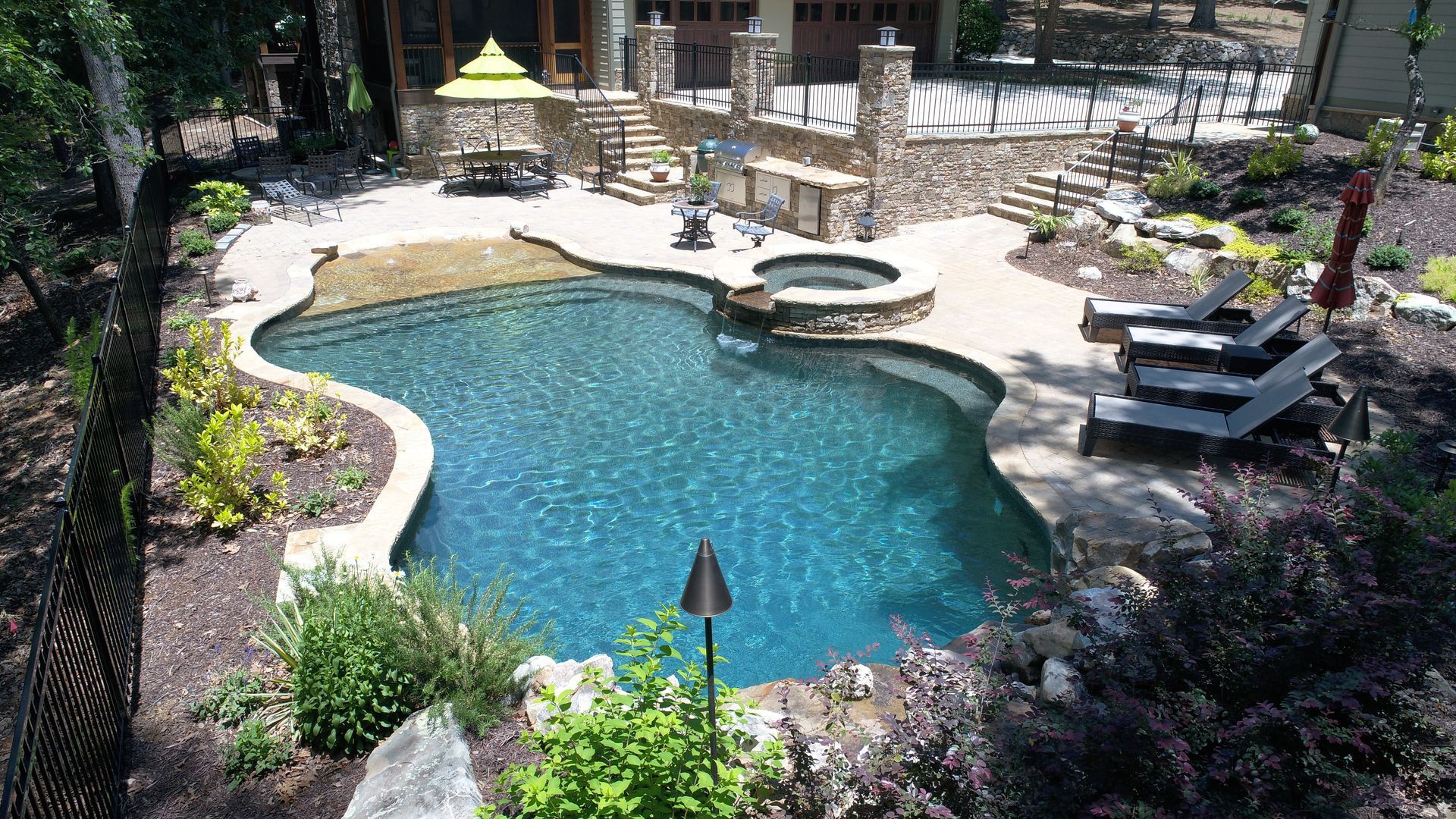 An aerial view of a swimming pool in the backyard of a house