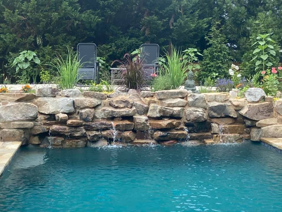 There is a waterfall in the middle of the pool.