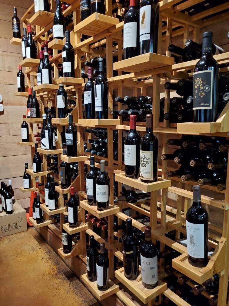Wine bottles on wooden shelves 