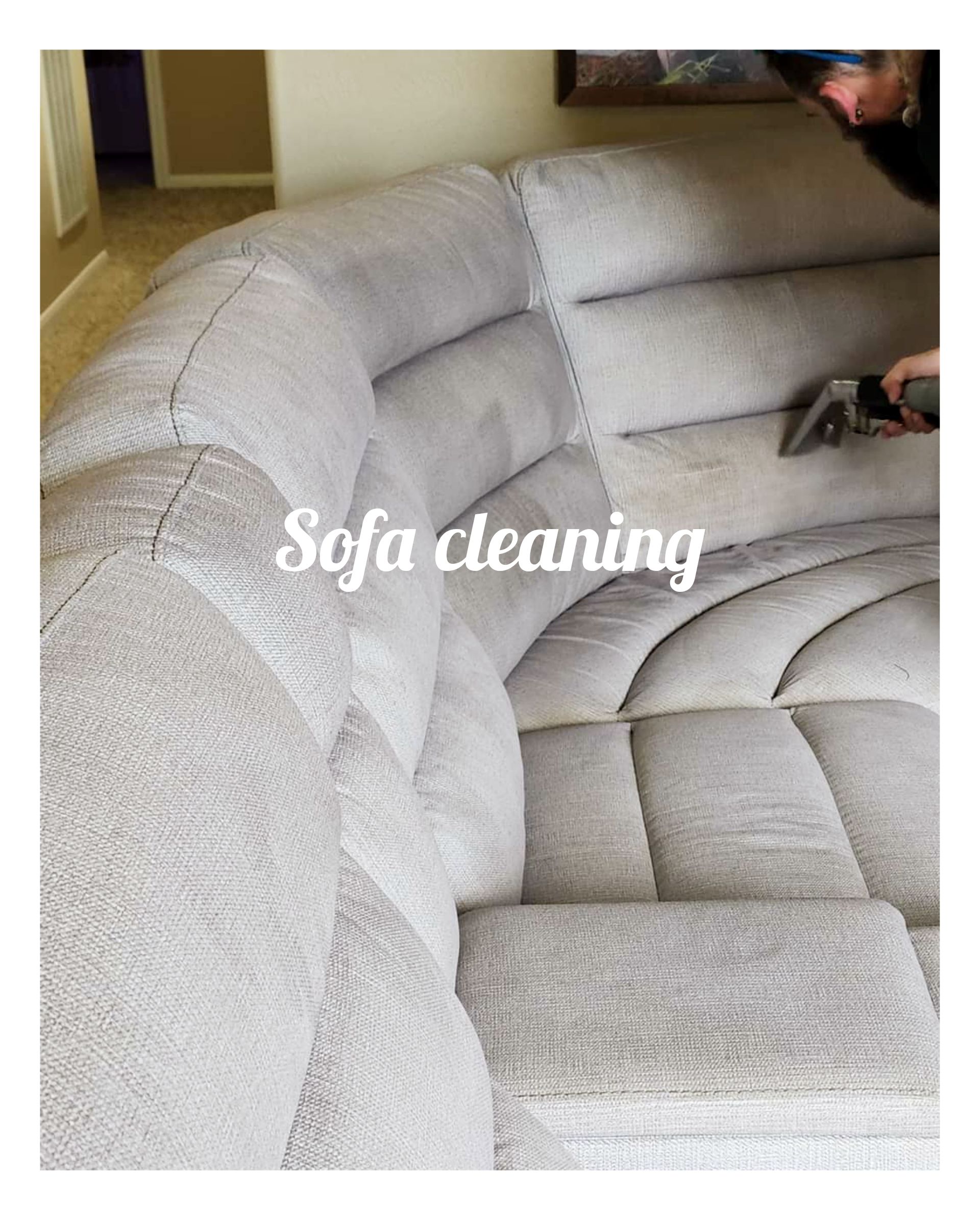 Cleaning a sectional sofa with a handheld upholstery cleaner.