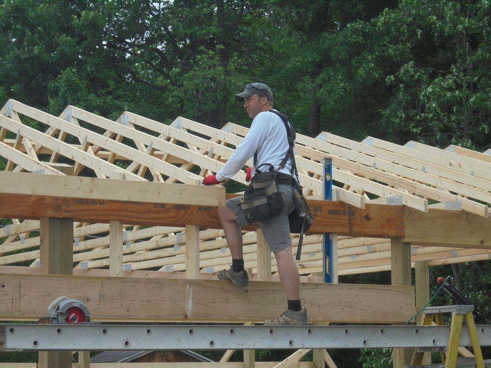 A man is standing on top of a wooden structure