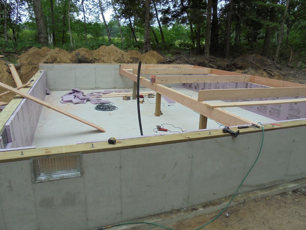 A concrete foundation is being built with wooden beams.