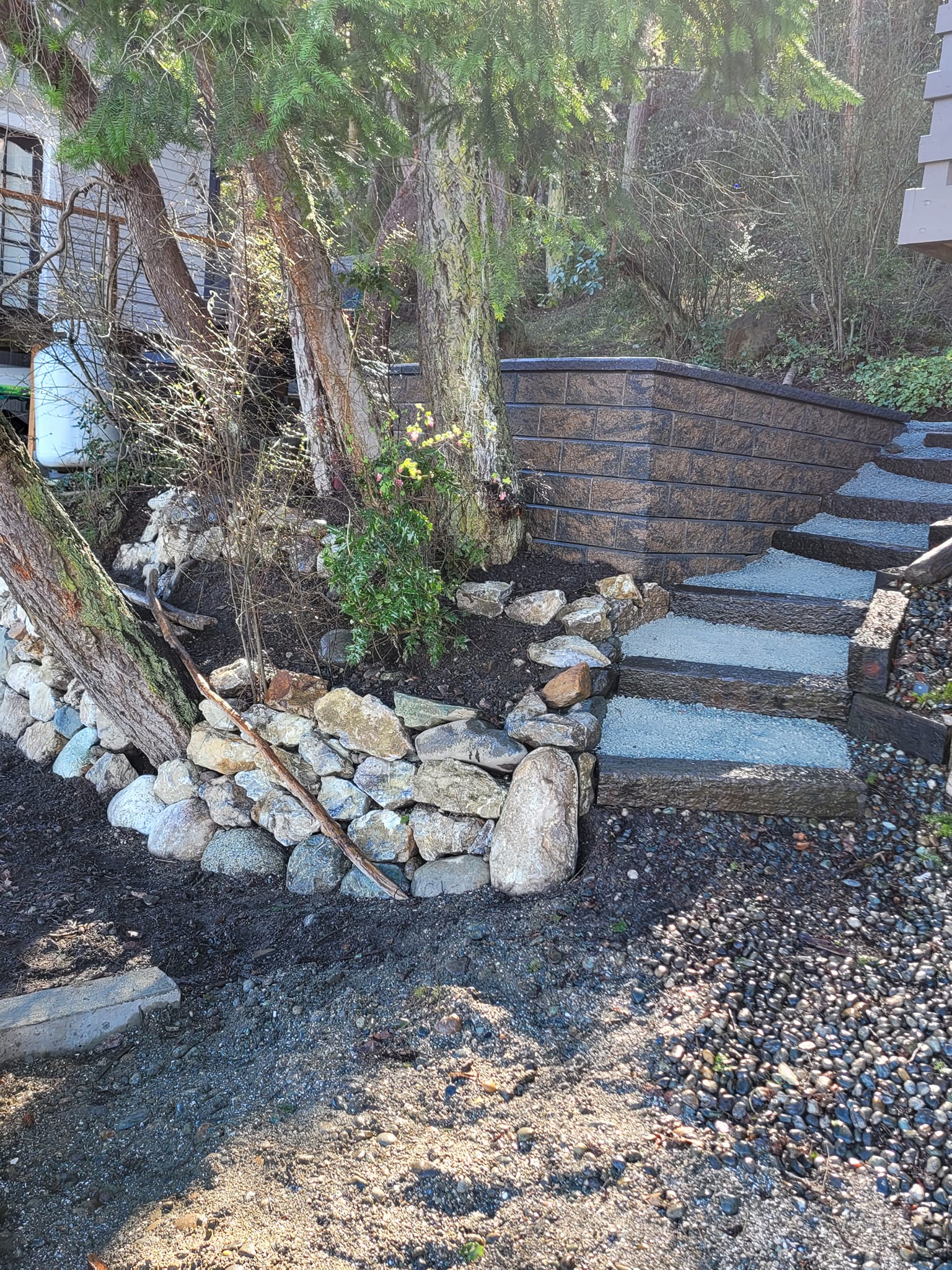 Sidewalk with new gravel steps and rock landscaping after