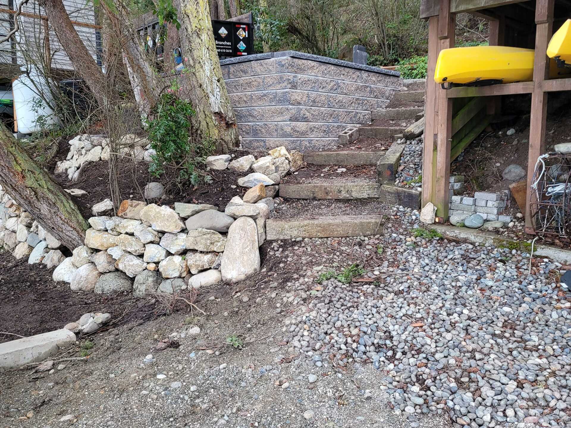 Sidewalk with new gravel steps and rock landscaping after