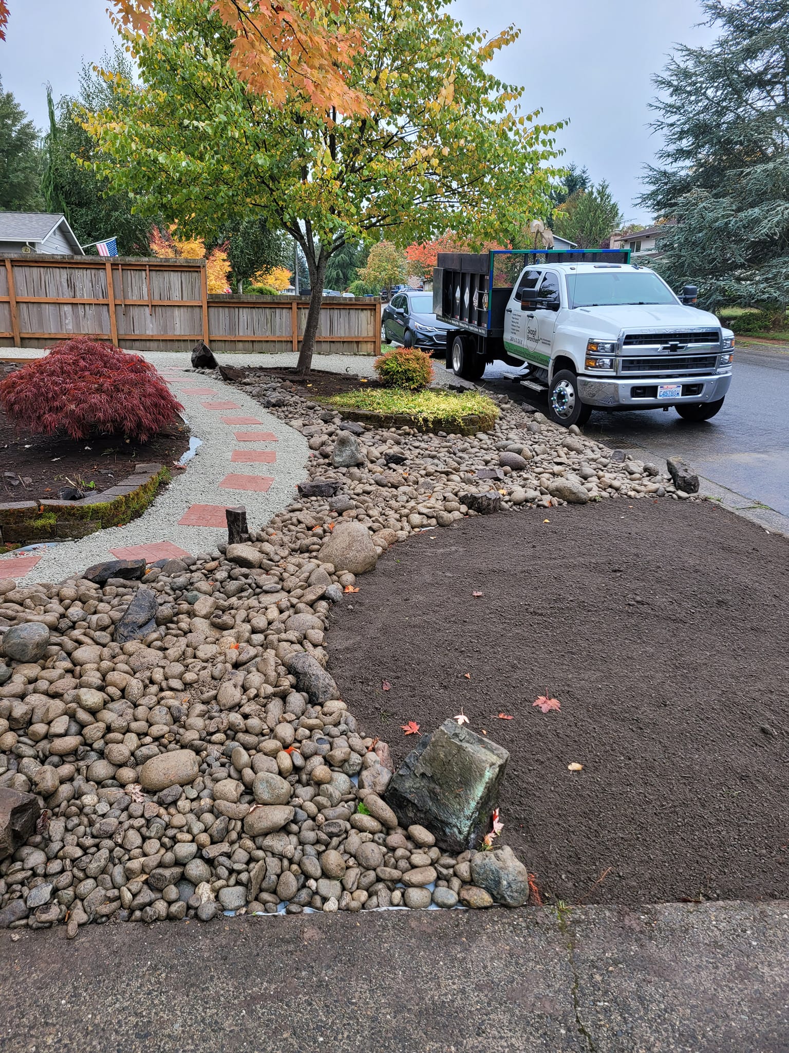 sidewalk and rock landscaping with Skagit Branches LLC Truck