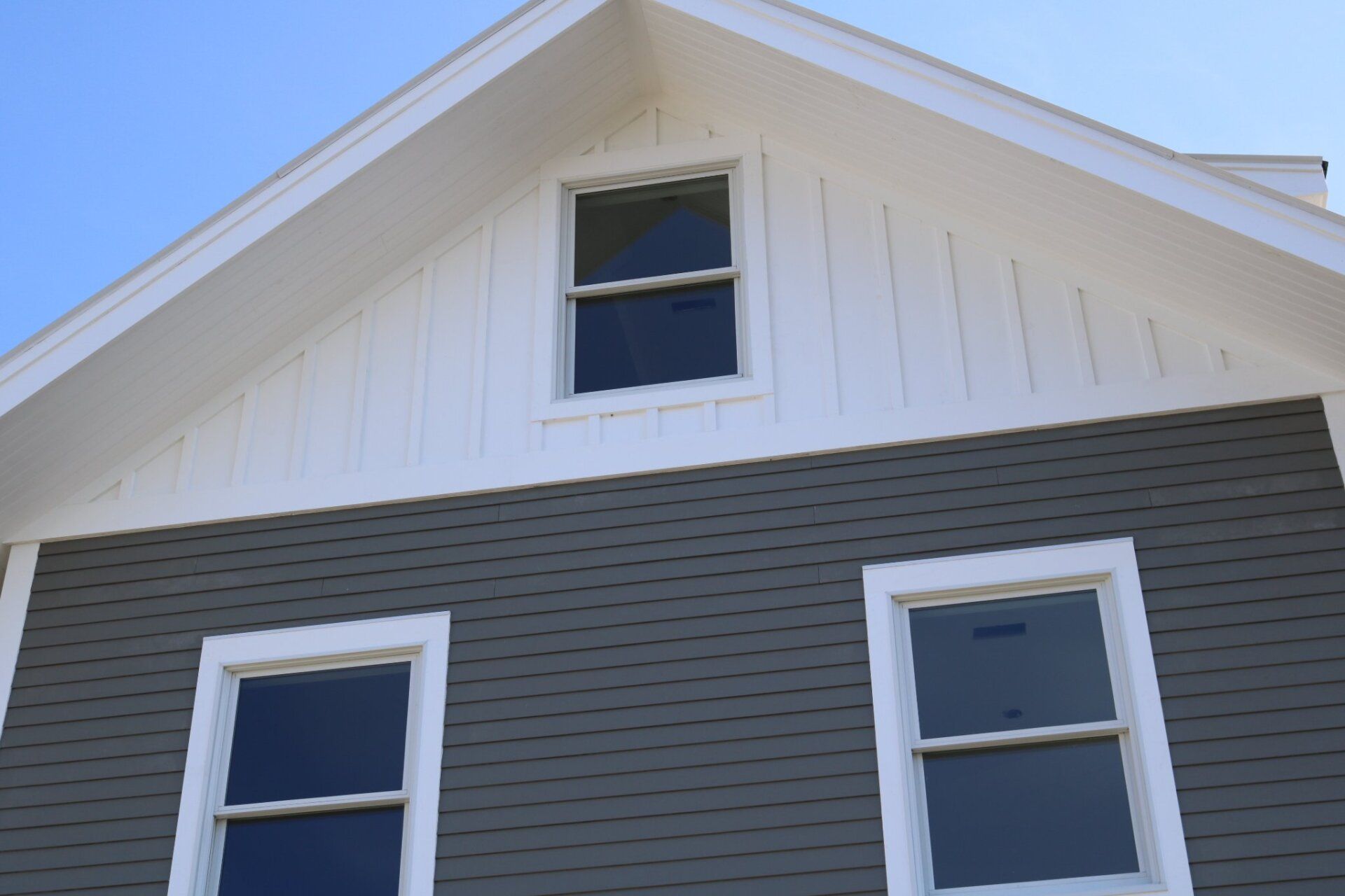 A house with two windows and a white roof