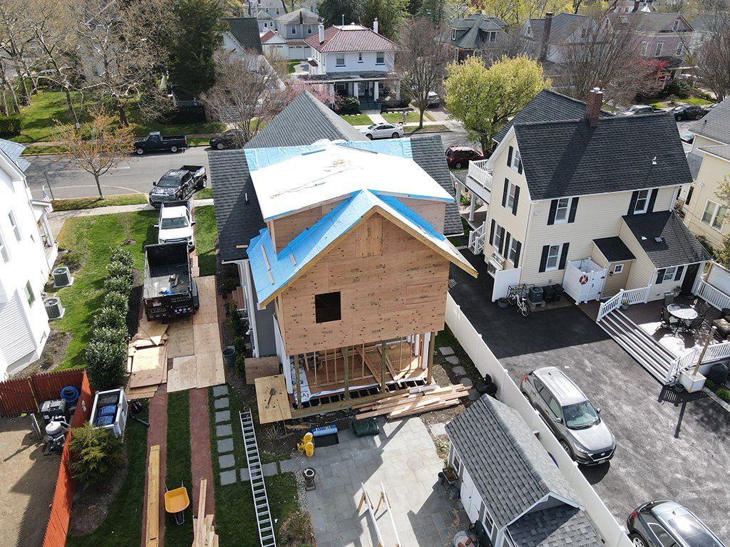 An aerial view of a house under construction in a residential area