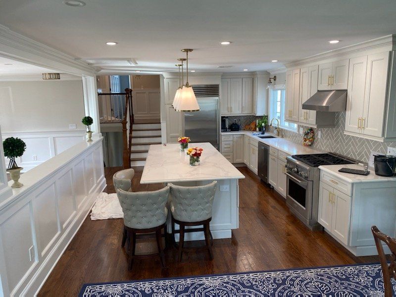 A kitchen with white cabinets and stainless steel appliances