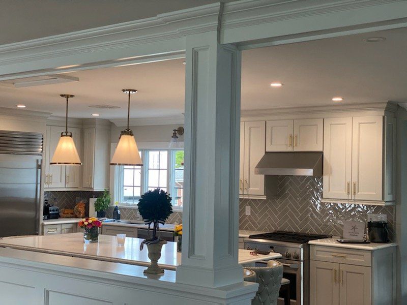 A kitchen with white cabinets and stainless steel appliances