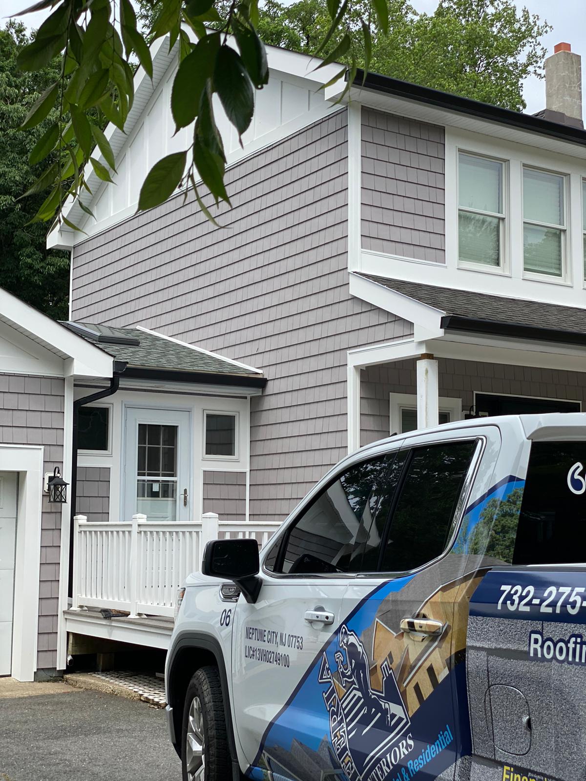 A truck is parked in front of a house.