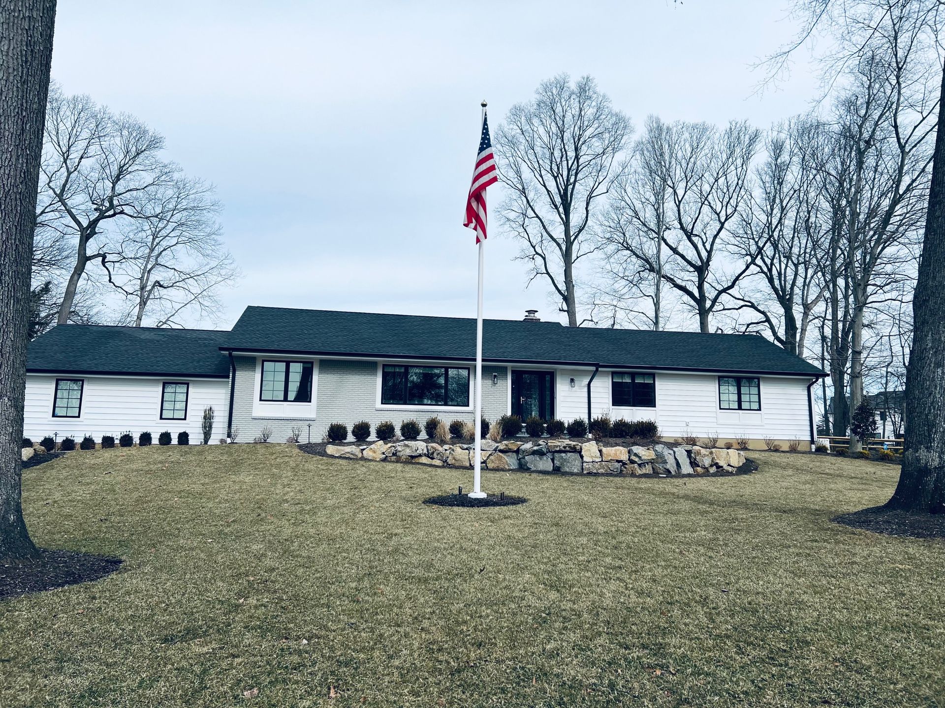 A house with a flag on a pole in front of it