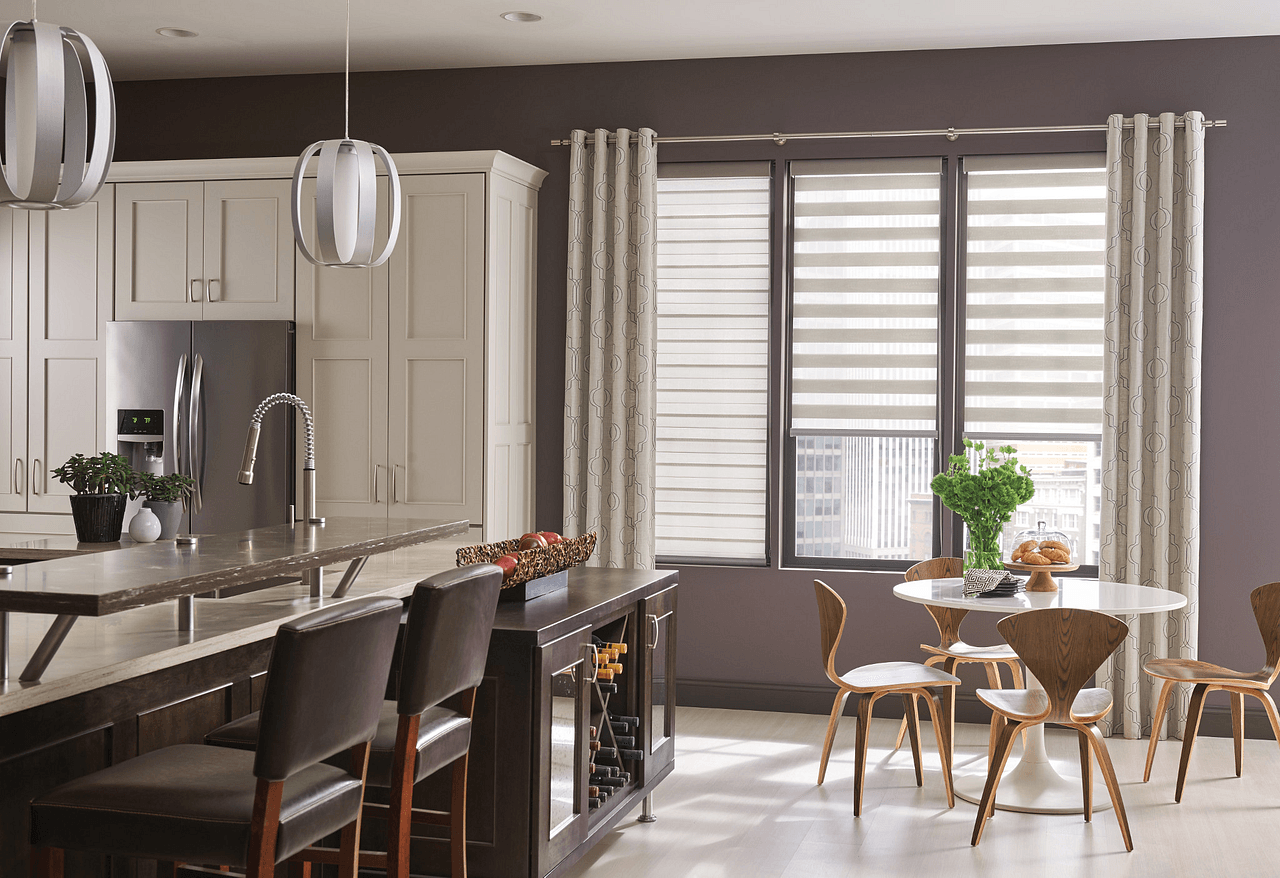 A kitchen with a table and chairs and a window with blinds.