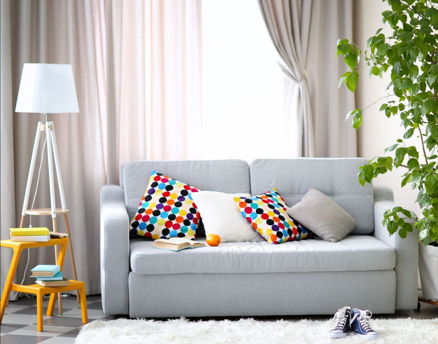 A living room with a couch and colorful pillows