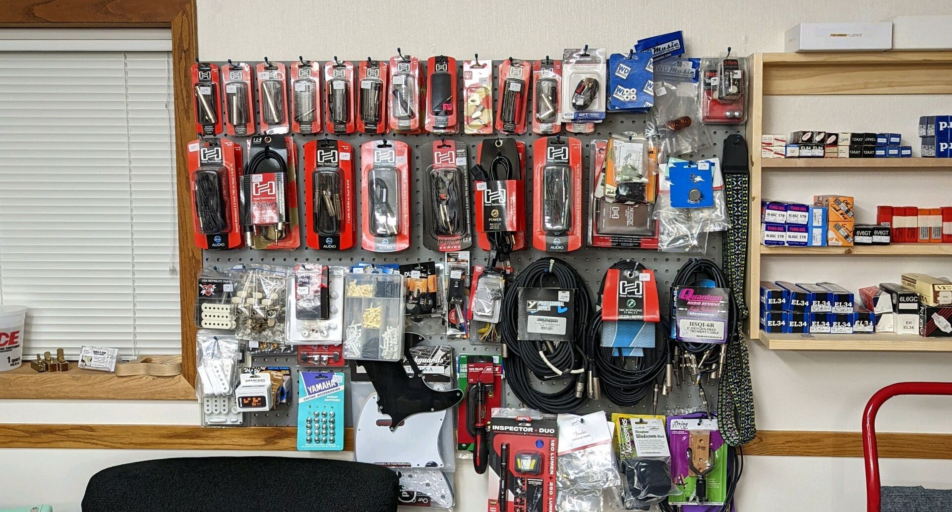 wall with cords and other audio packaged equipment