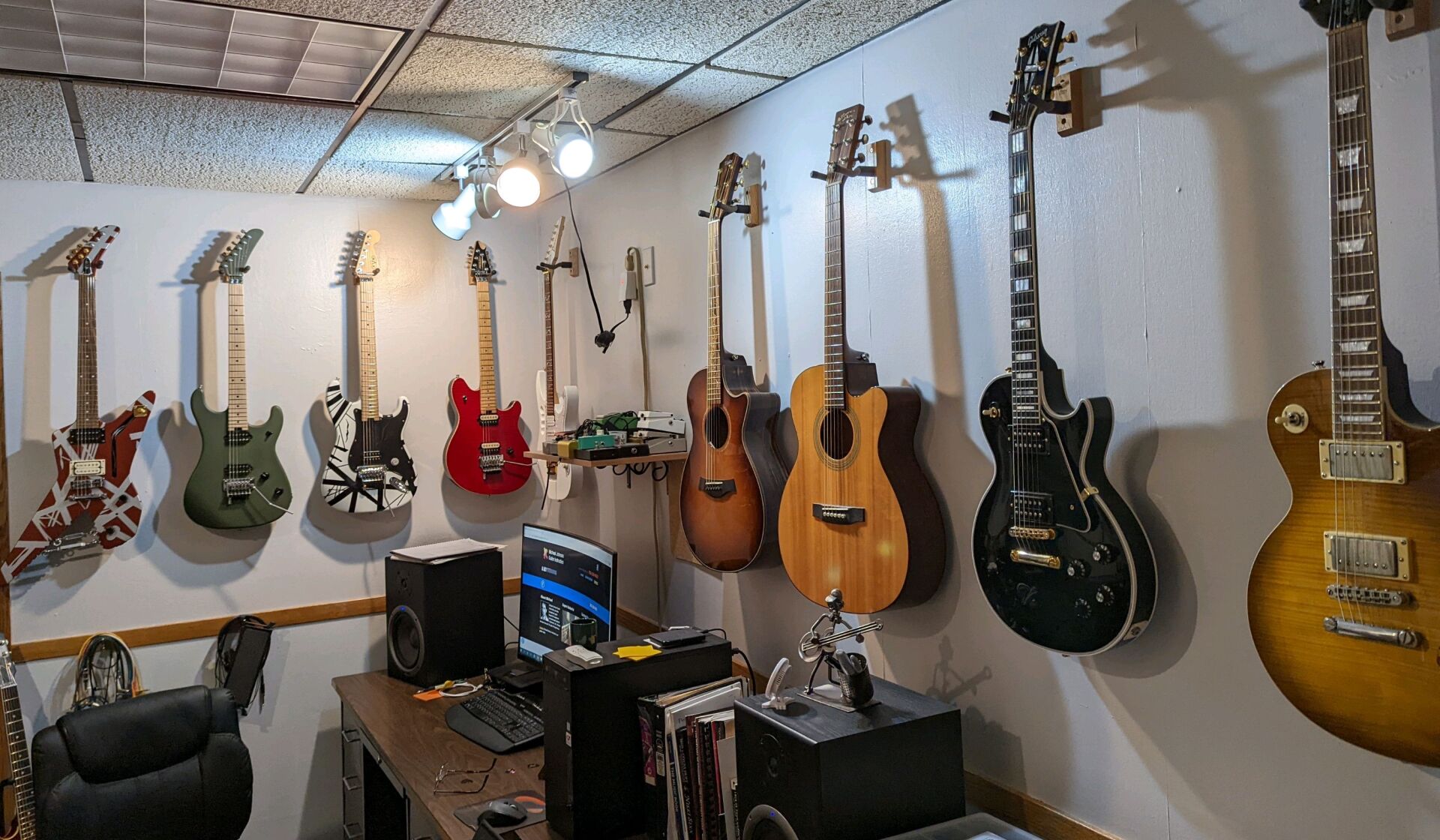 Electric guitars and acoustic guitars hanging on the wall