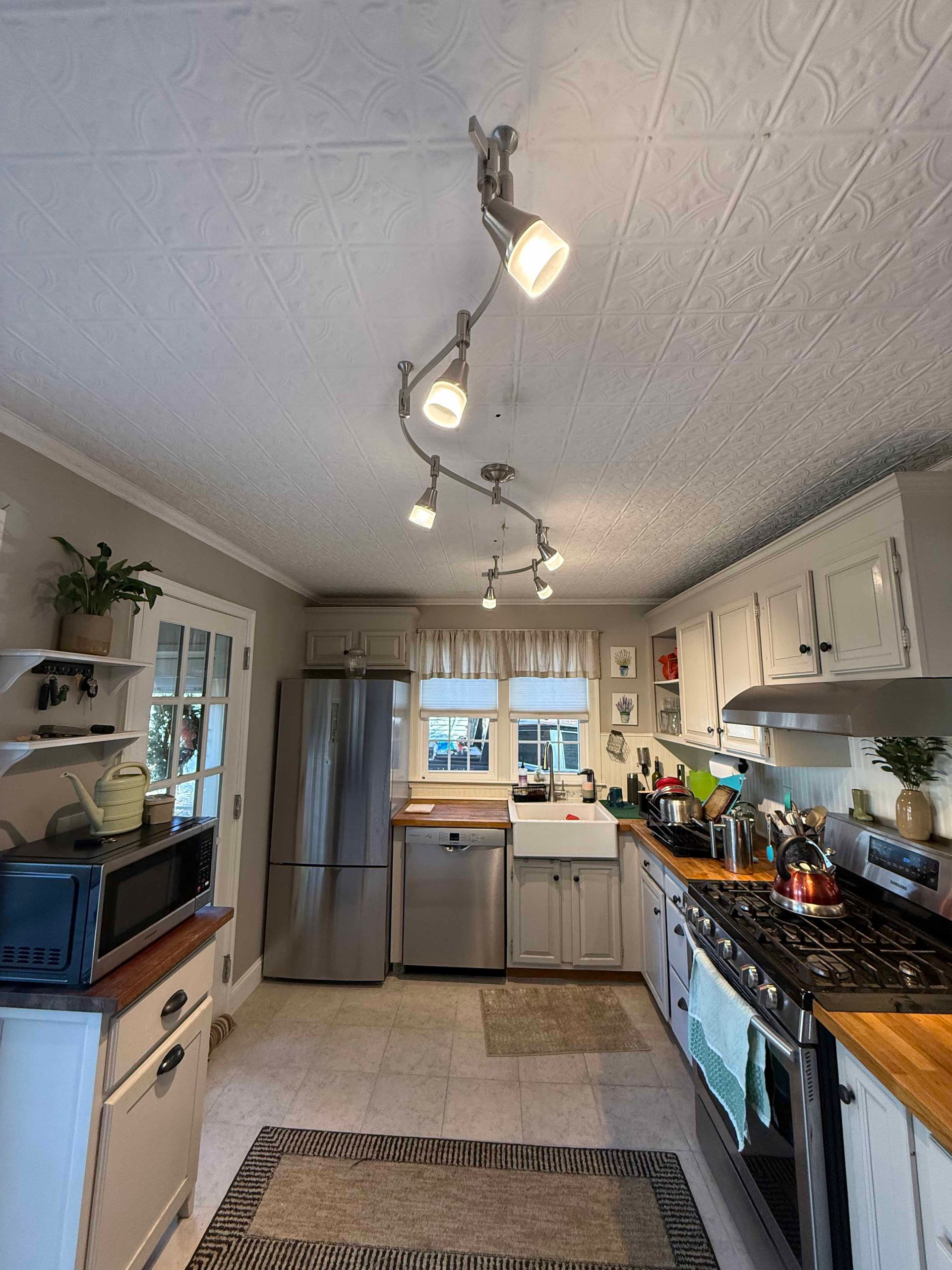 A kitchen with stainless steel appliances and white cabinets