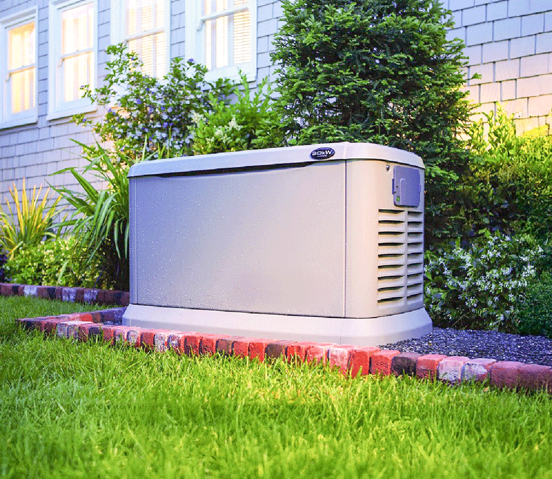 A generator is sitting in the grass in front of a house.