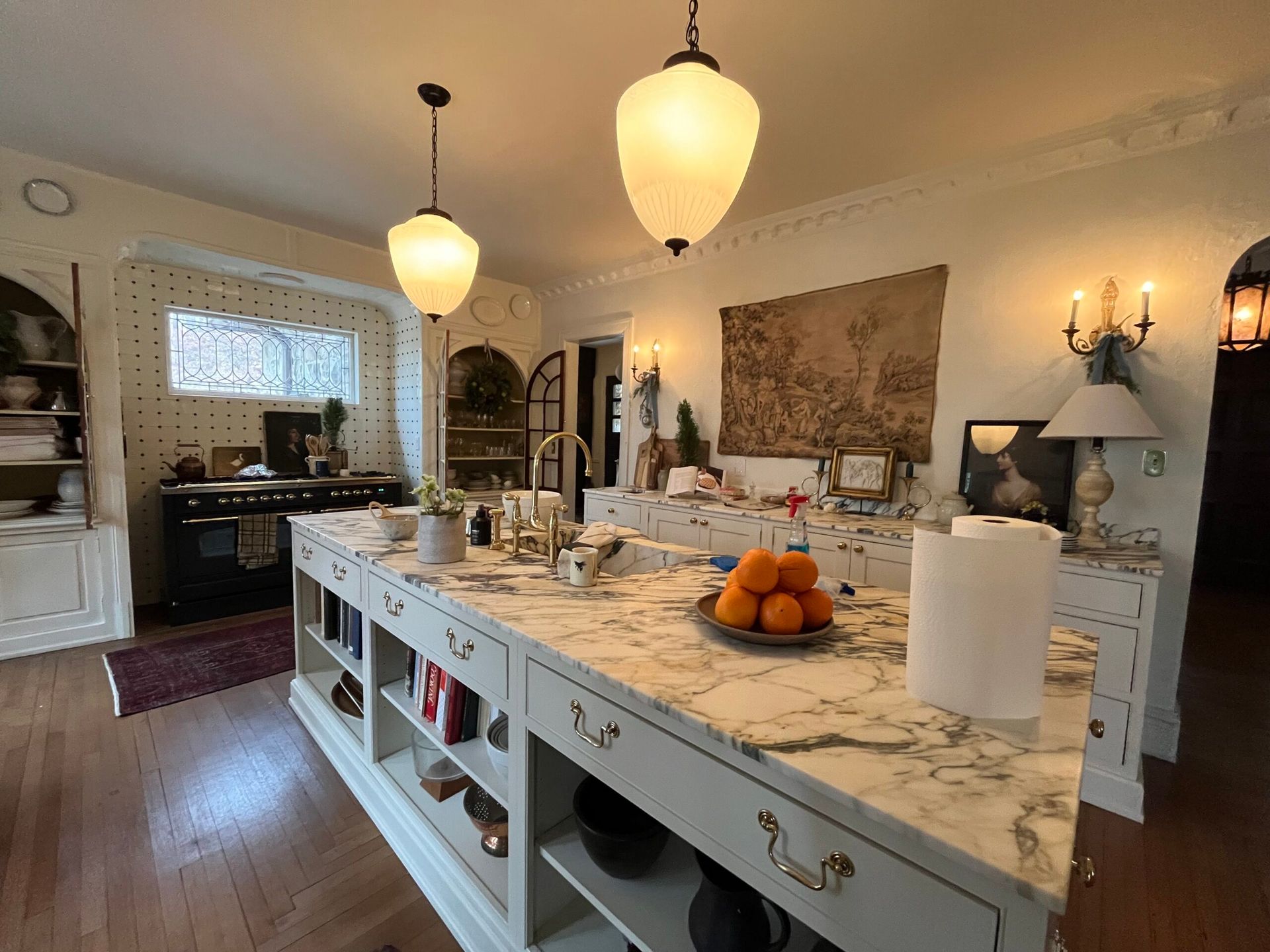 A kitchen with a large island and marble counter tops.