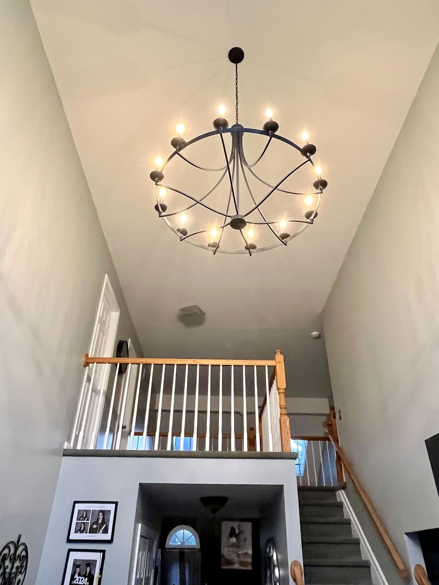 A large chandelier is hanging from the ceiling of a living room.