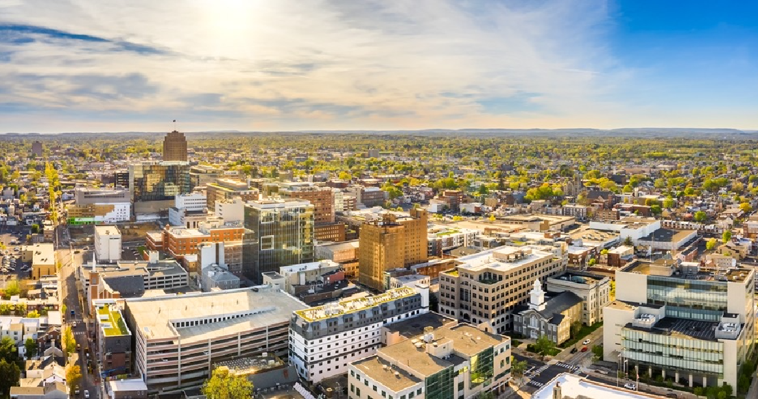 An aerial view of a city with lots of buildings and trees.
