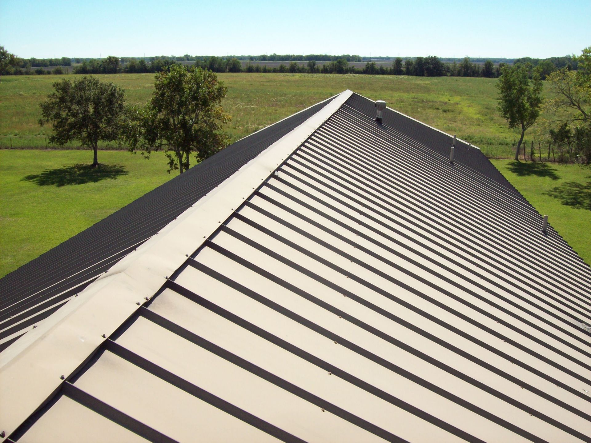 The roof of a building with trees in the background