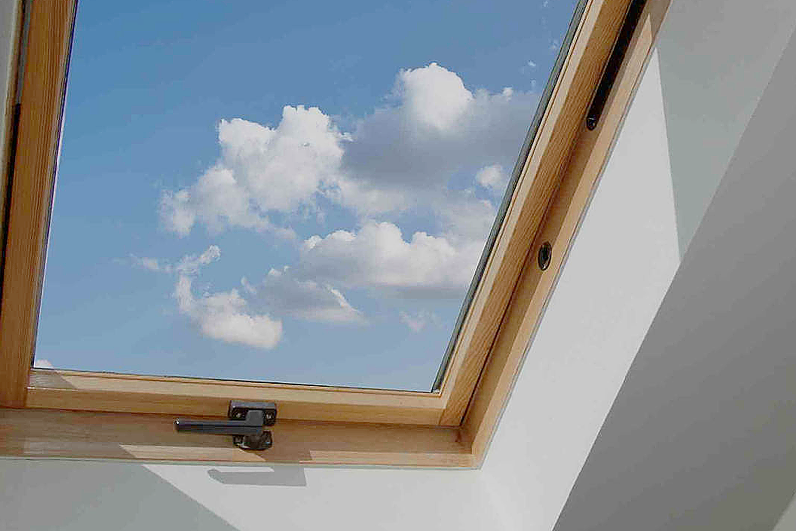 a skylight with a blue sky and clouds visible through it