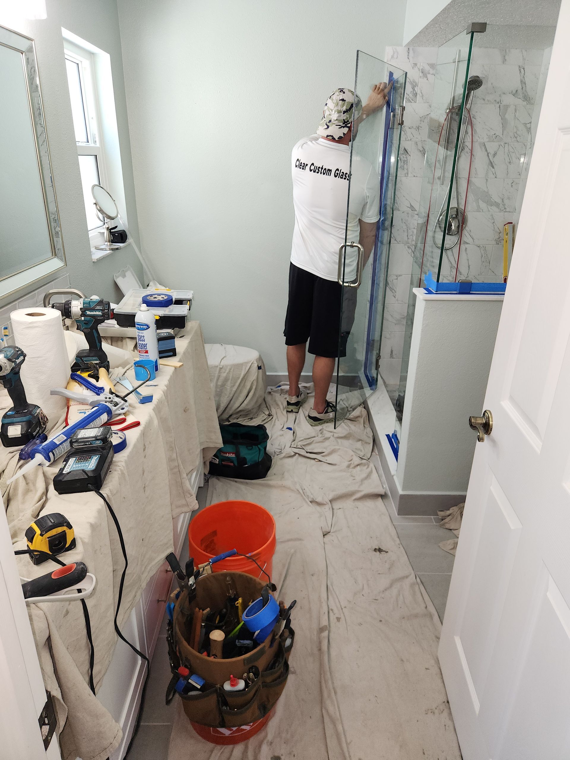 Man installing a shower door