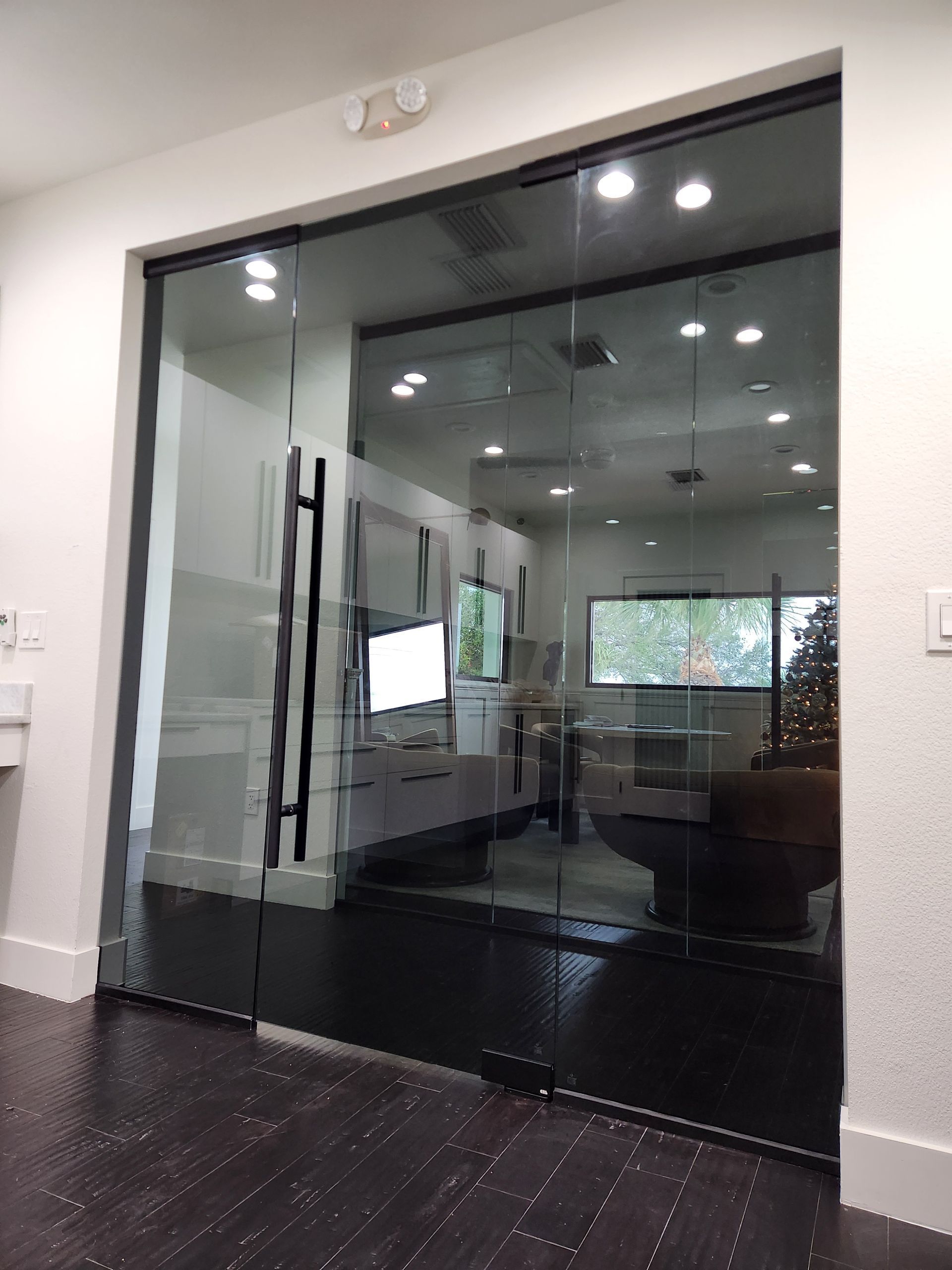 A room with a sliding glass door and a black handle