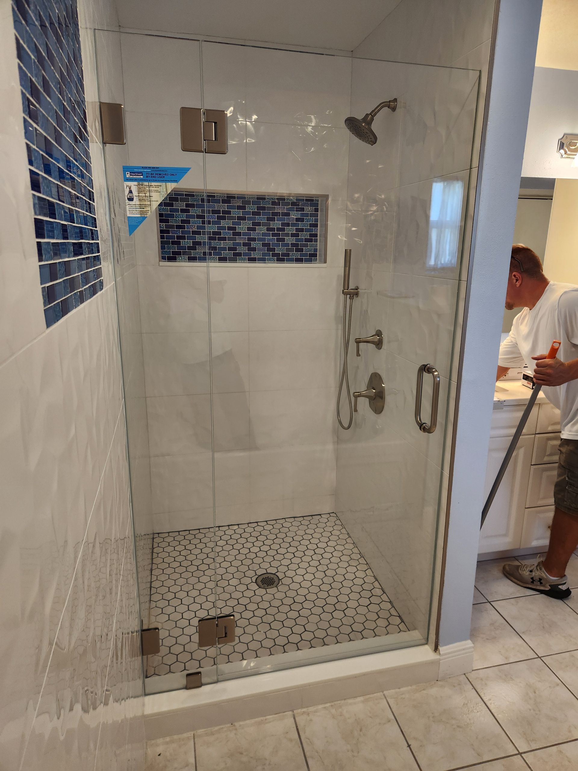 Shower with brushed nickel clamps