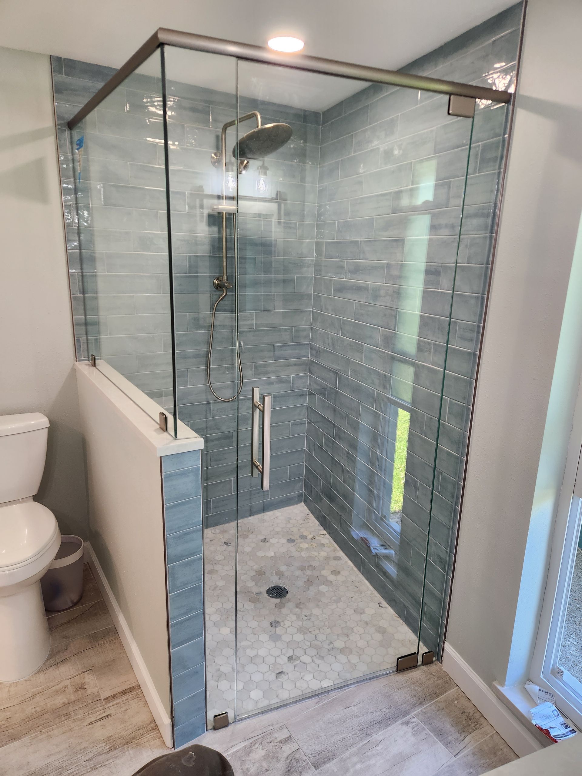 a bathroom with a walk in shower and a toilet